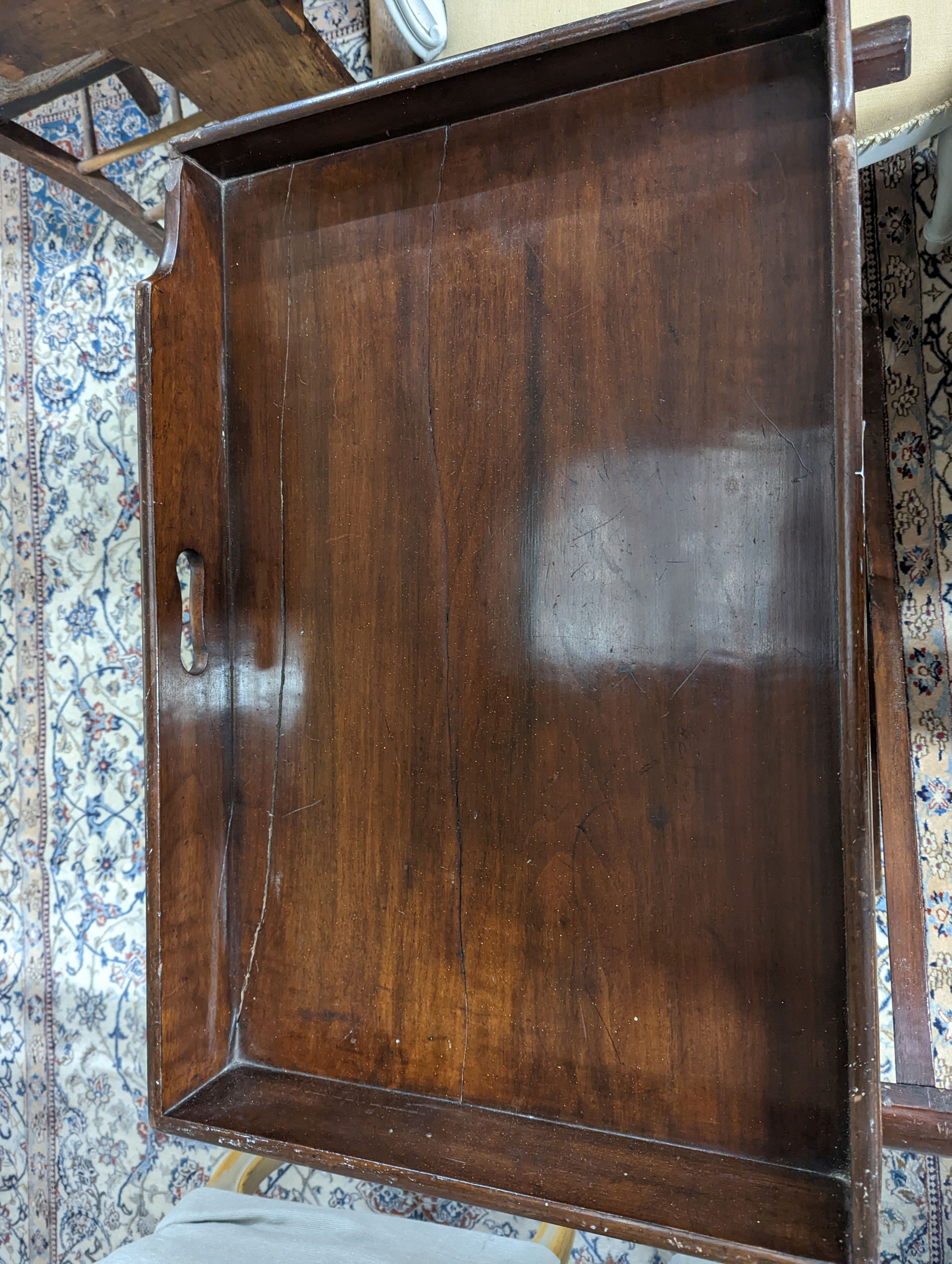 A 19th century rectangular mahogany butler's tray on folding stand, width 24cm, depth 49cm, height 71cm